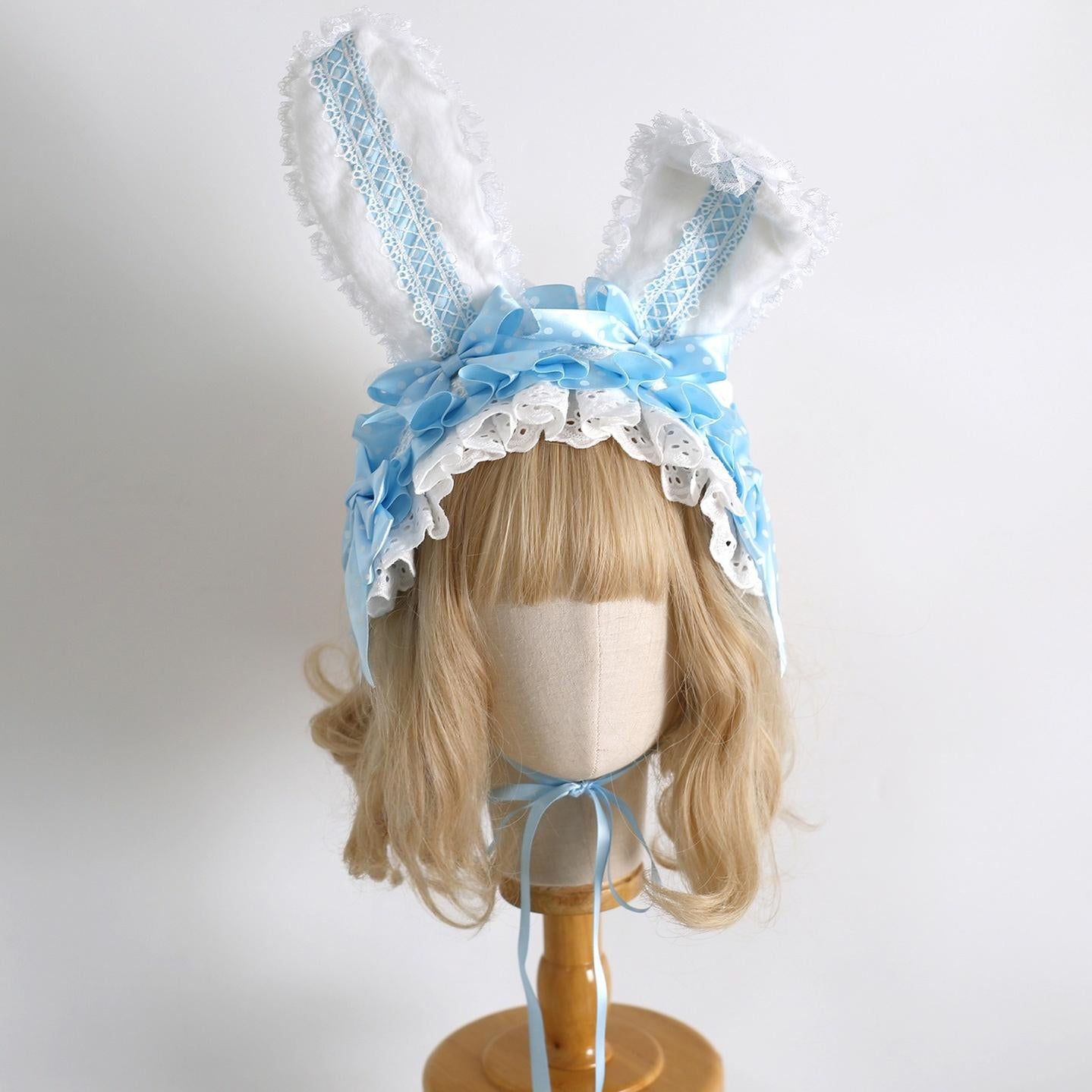 Baby blue sweet lolita bunny ear hairband with white ruffled lace trim on mannequin blonde curly wig