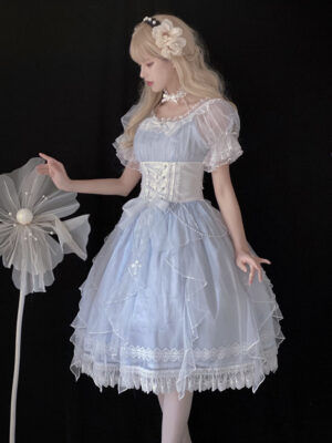Mermaid Princess light blue Lolita short sleeve OP dress full body three quarter view with blonde model wearing flower hair accessory, featuring sheer mesh puff sleeves with lace trim, white corset waistband, A-line silhouette with ruffled lace hem