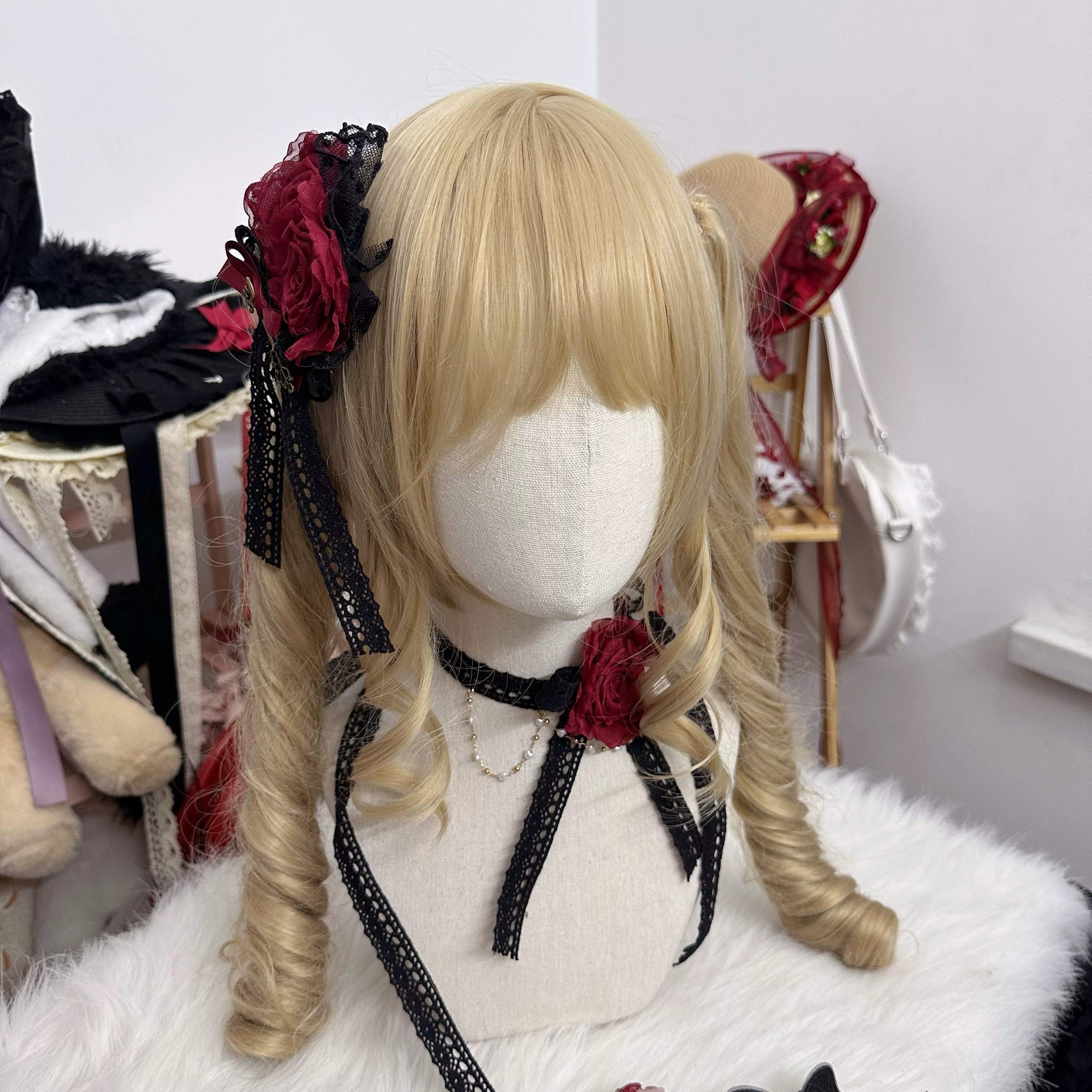 Ivory cream Lolita lace flower headdress and choker set with rose accents displayed full view on blonde curly twin tail wig in craft studio setting