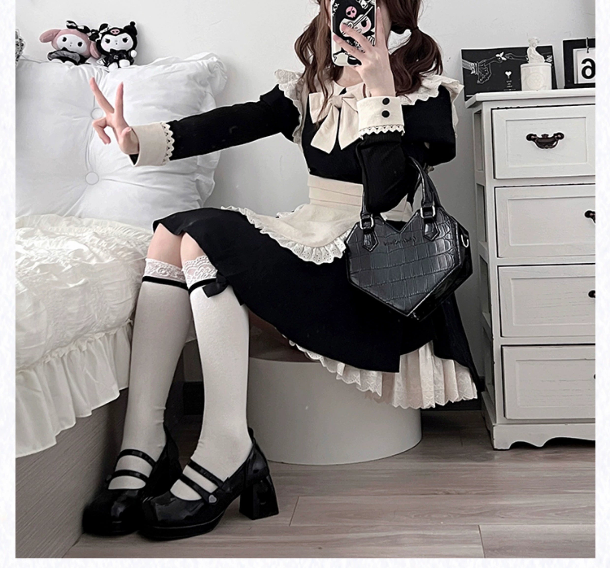 Maid lolita dress showing apron construction and decorative bow details close-up