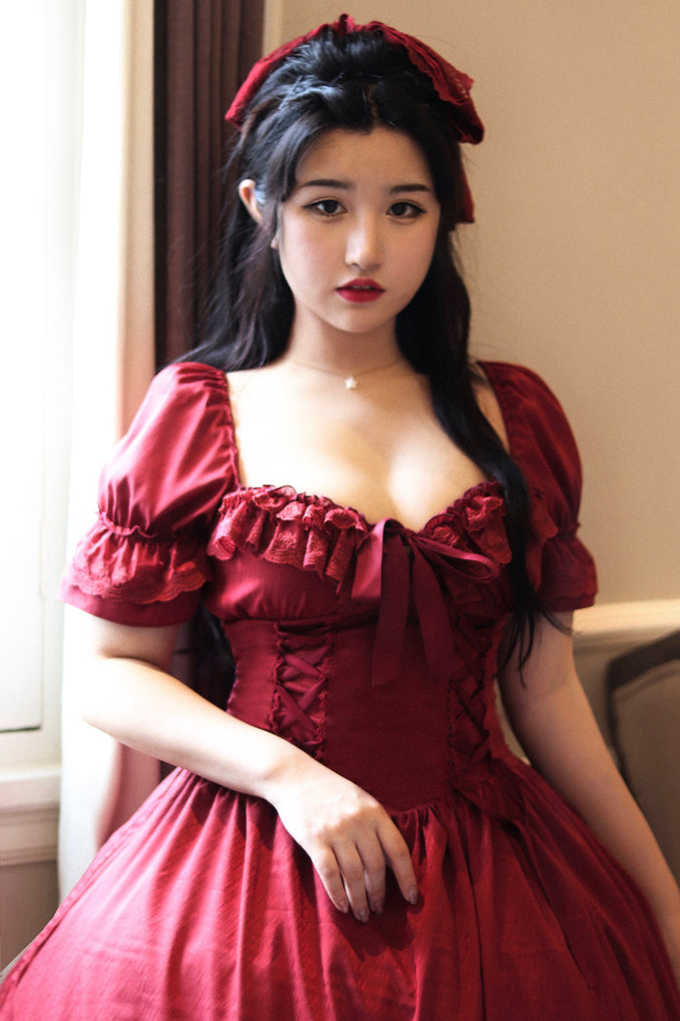 Burgundy French Lolita OP dress with square neck puff sleeves, chest bow ruffled trim and lace-up waist design, half-body front view on plain background