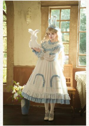 Single model wearing classic lolita OP dress with blue ruffled collar, puffed sleeves, and arched skirt embroidery paired with soft lop bunny ear hairband and plush rabbit toy