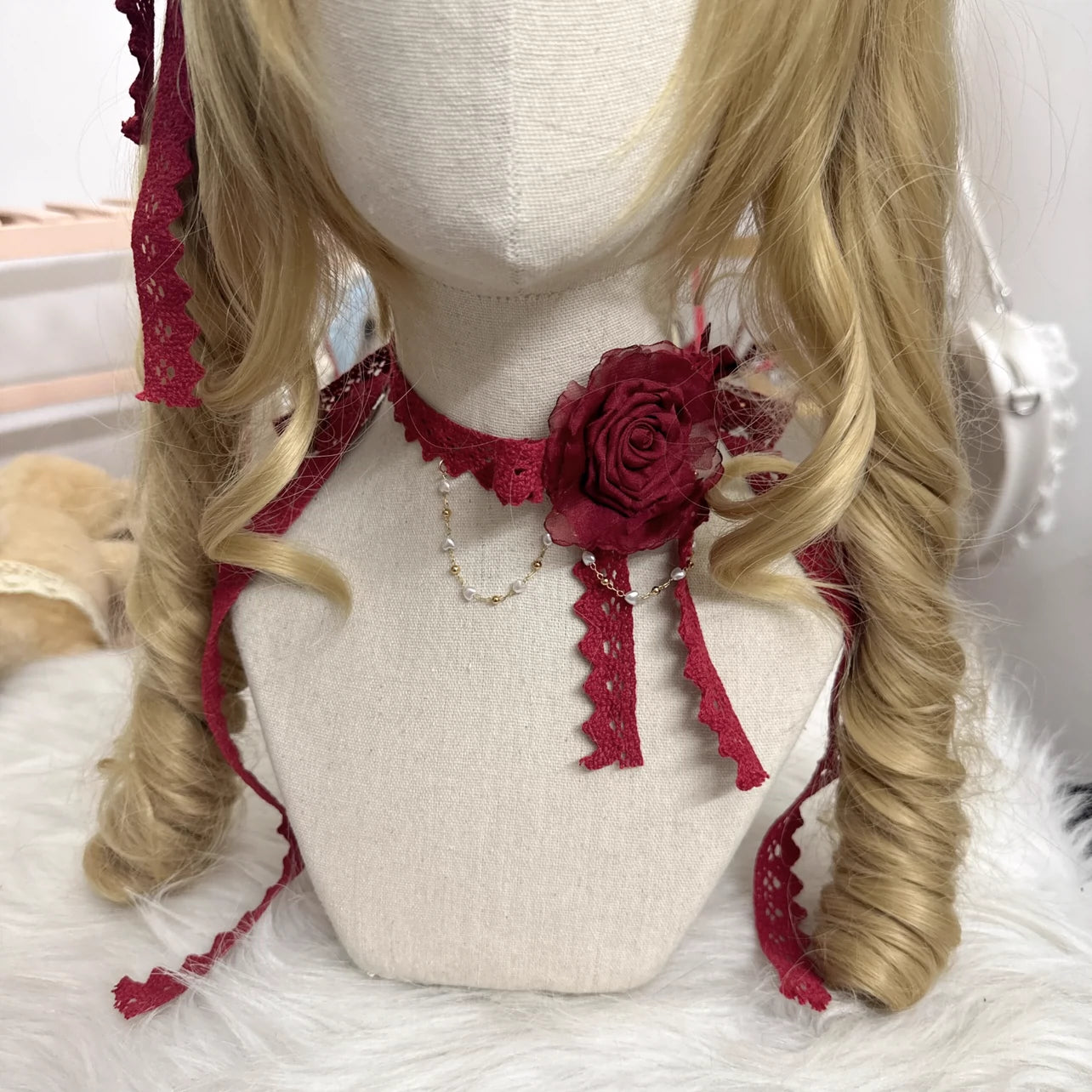 Front close-up of Lolita red lace rose choker with large burgundy fabric rose and layered pearl necklace accents, showing detailed lace ribbon construction