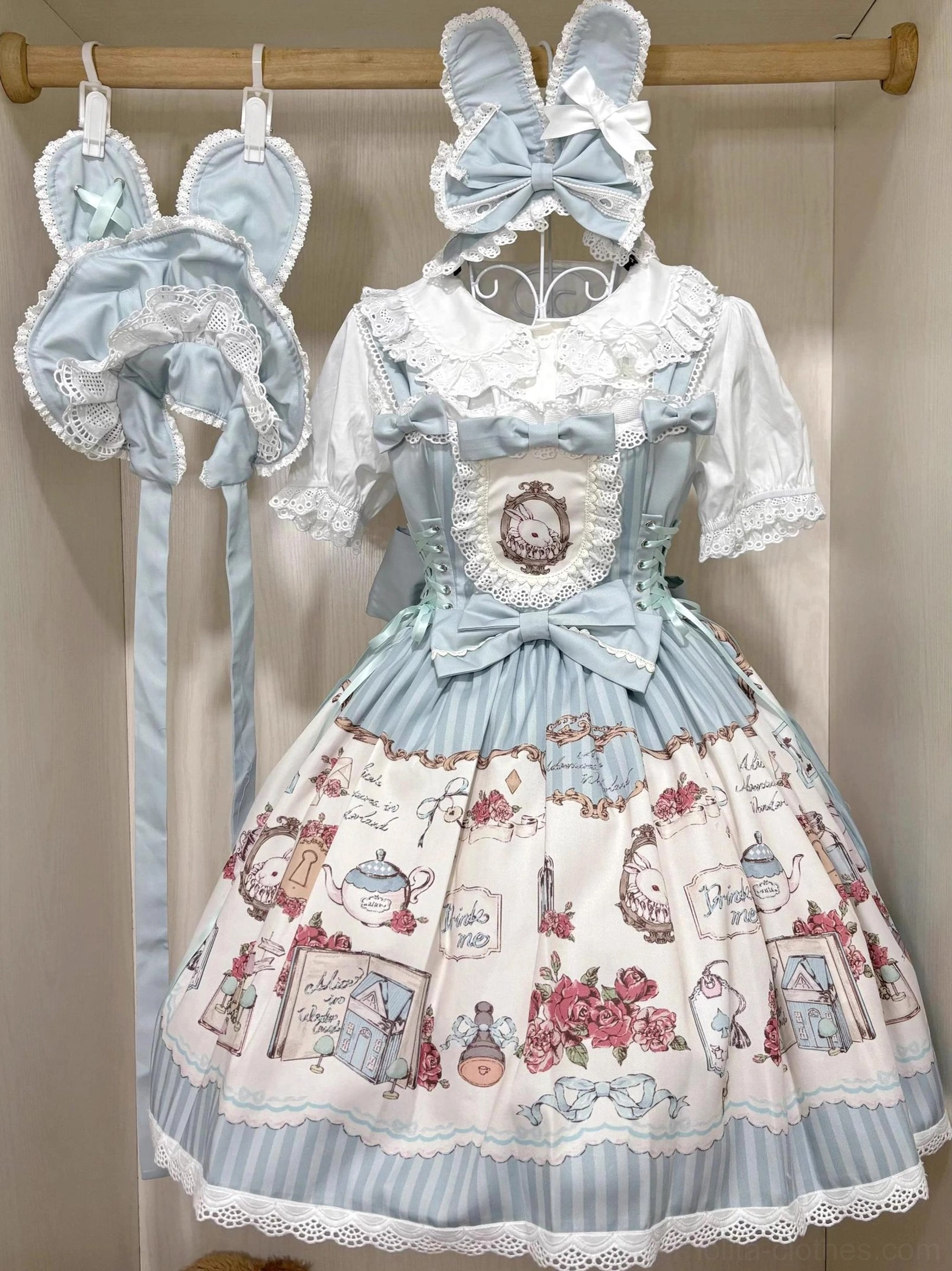 Full sky blue alice-themed lolita outfit coordinate with white peter pan collar blouse, corset suspender skirt, rose and teapot print patterns, scalloped lace hem, bunny ear headbow and hair clip accessories