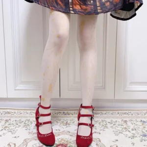 Angel constellation white x gold print lolita tights with golden celestial motifs on sheer black base styled with printed lolita skirt and red double-strap Mary Jane shoes