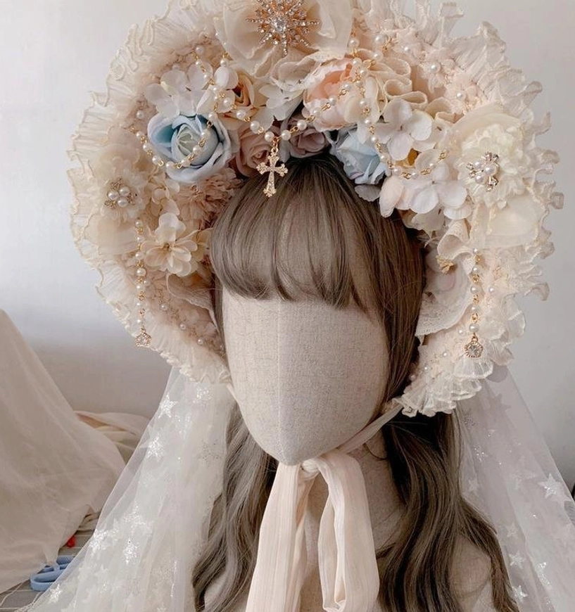Apricot floral Lolita bonnet hat with delicate cream flowers, blue roses, feather accents, and pearl hair ornaments styling detail