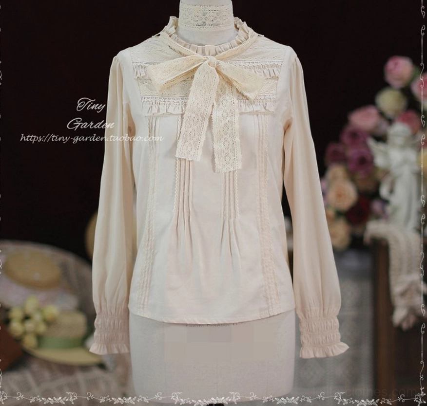 Front full display of apricot beige Lolita long-sleeve blouse on dress mannequin featuring lace bow necktie, ruffled stand collar, and front pin-tuck decorative panels against retro floral studio background