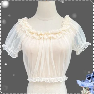 Apricot sheer mesh short-sleeve Lolita blouse with ruffled round neckline puff sleeves and elastic cuffs displayed on dress form with starry backdrop