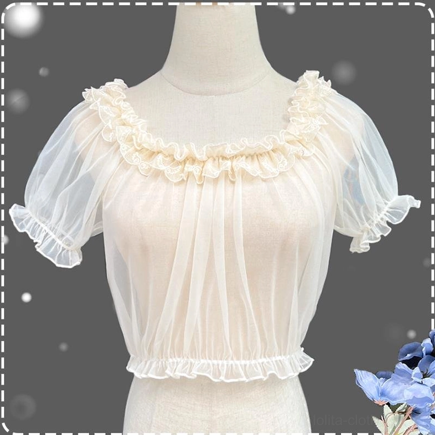 Apricot sheer mesh short-sleeve Lolita blouse with ruffled round neckline puff sleeves and elastic cuffs displayed on dress form with starry backdrop