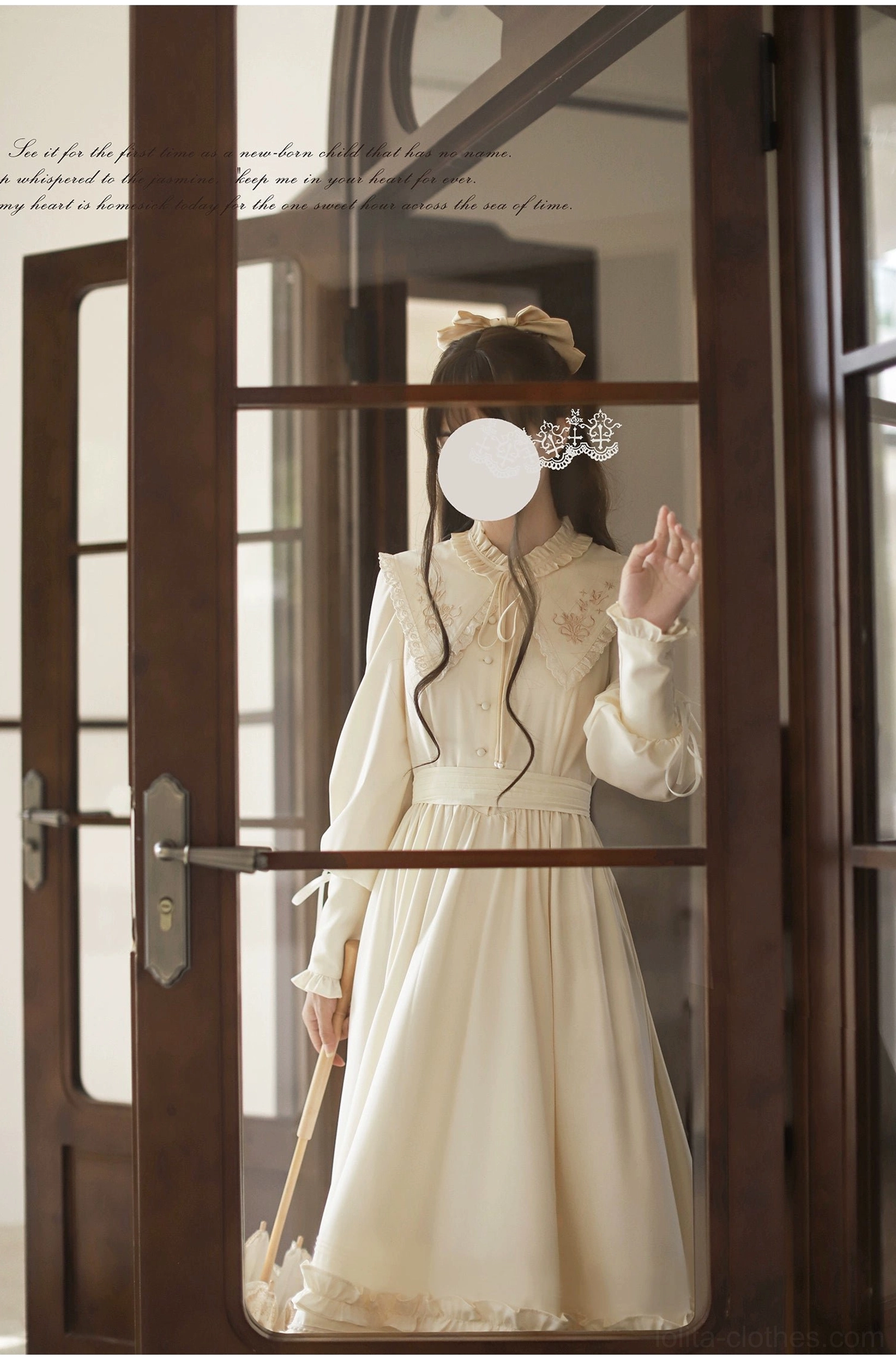 Full-body view of apricot Lolita OP dress through glass doorway, fitted waist design, long sleeves, warm cream apricot color, model standing and waving behind vintage glass door