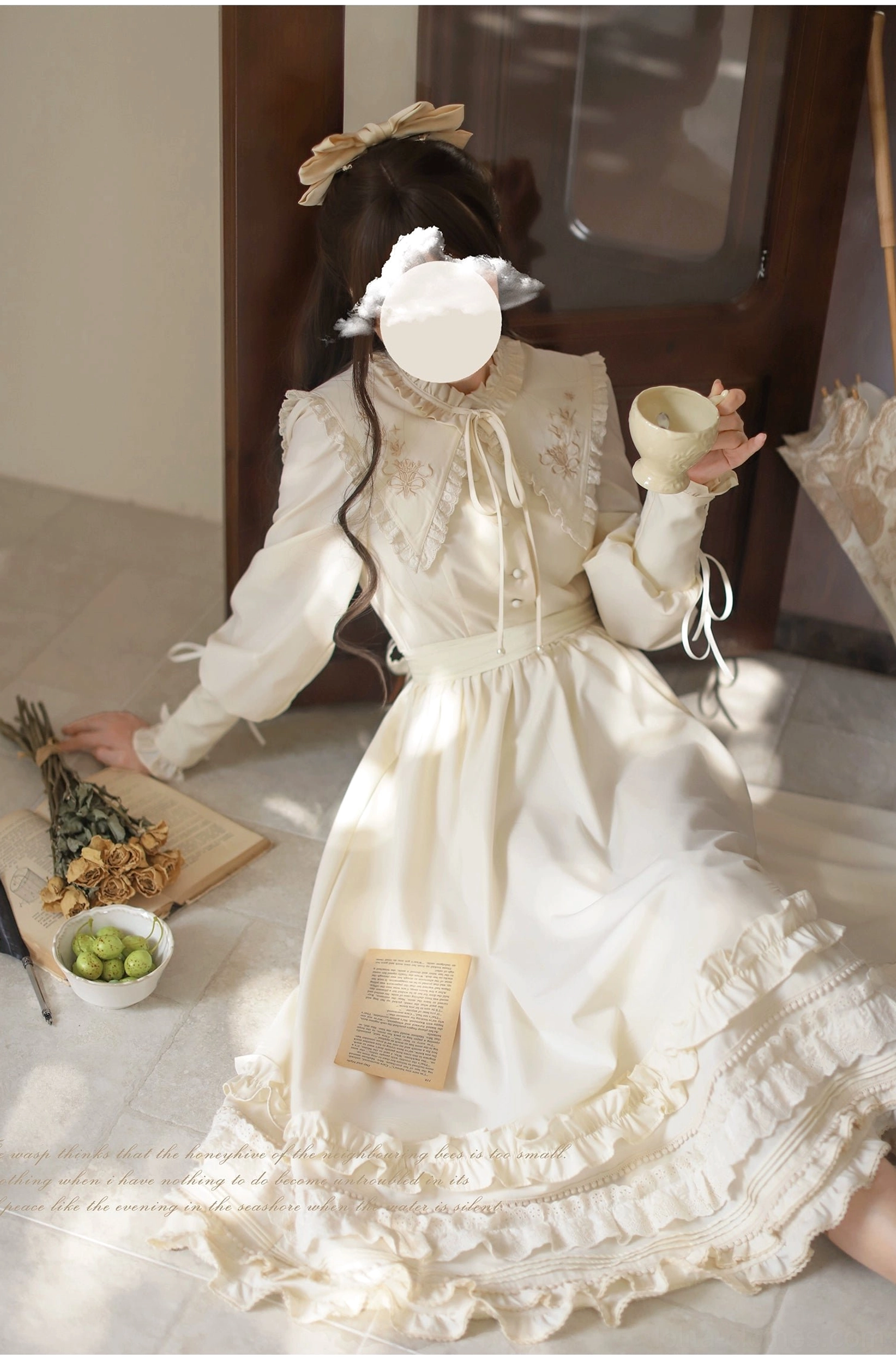 Three-quarter seated side profile of apricot classic Lolita OP dress, ribbon-tie collar detail, lace-trimmed bodice, layered ruffled skirt hem, tea party setting with teacup
