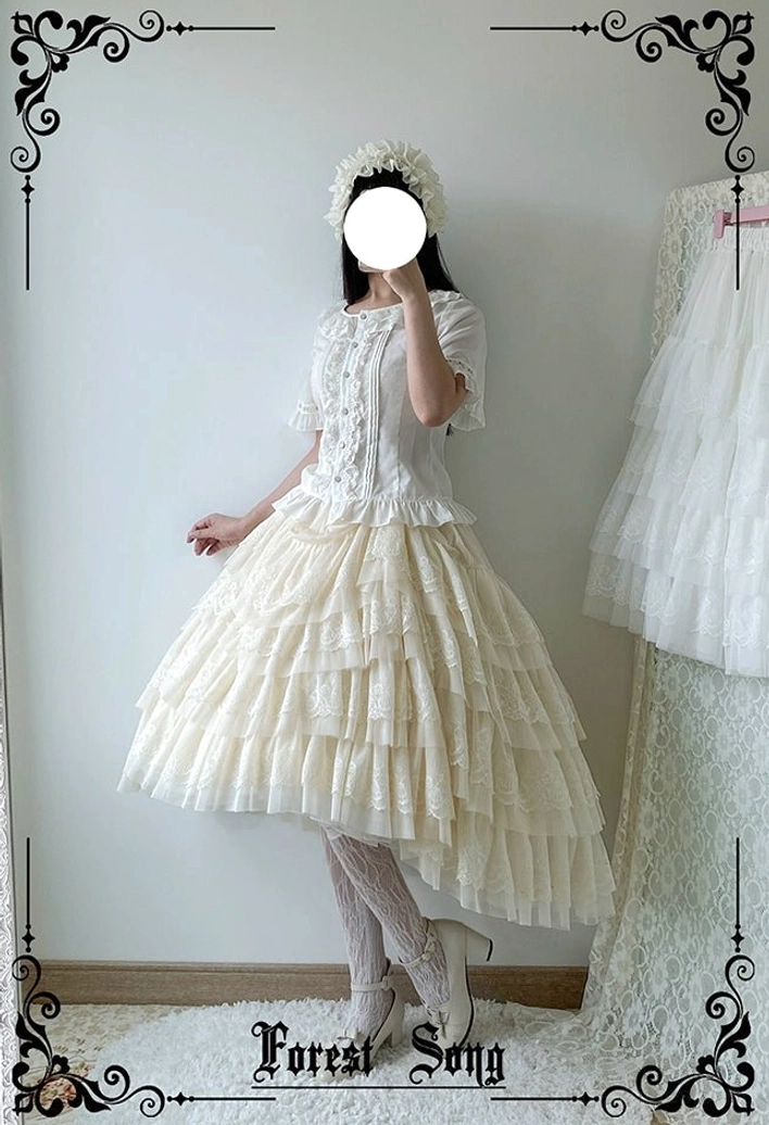 Apricot beige lolita petticoat front three-quarter angle on model with floral hair accessory displaying soft layered tulle ruffles and romantic silhouette