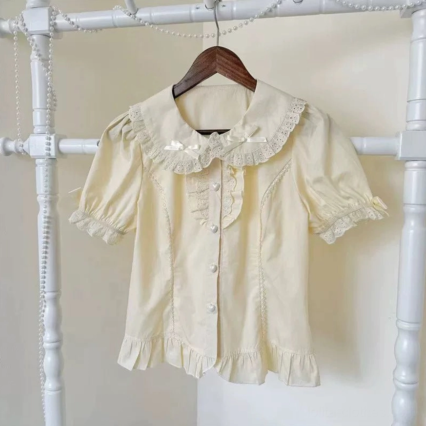 Short sleeve apricot beige lolita blouse peter pan lace trimmed collar puff sleeves ruffled hem hanging display front view