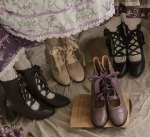 Assorted classic lolita ankle boots collection in black beige and purple with cross-strap lace closures round toe block heel vintage aesthetic flat lay display
