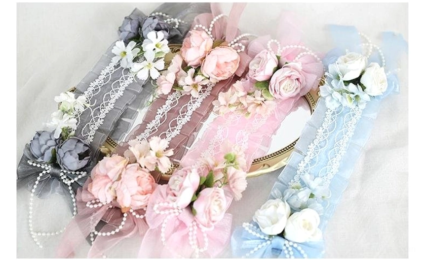 Assorted color lolita floral headbands collection flat lay displaying pink light blue and dark gray options with matching flower details
