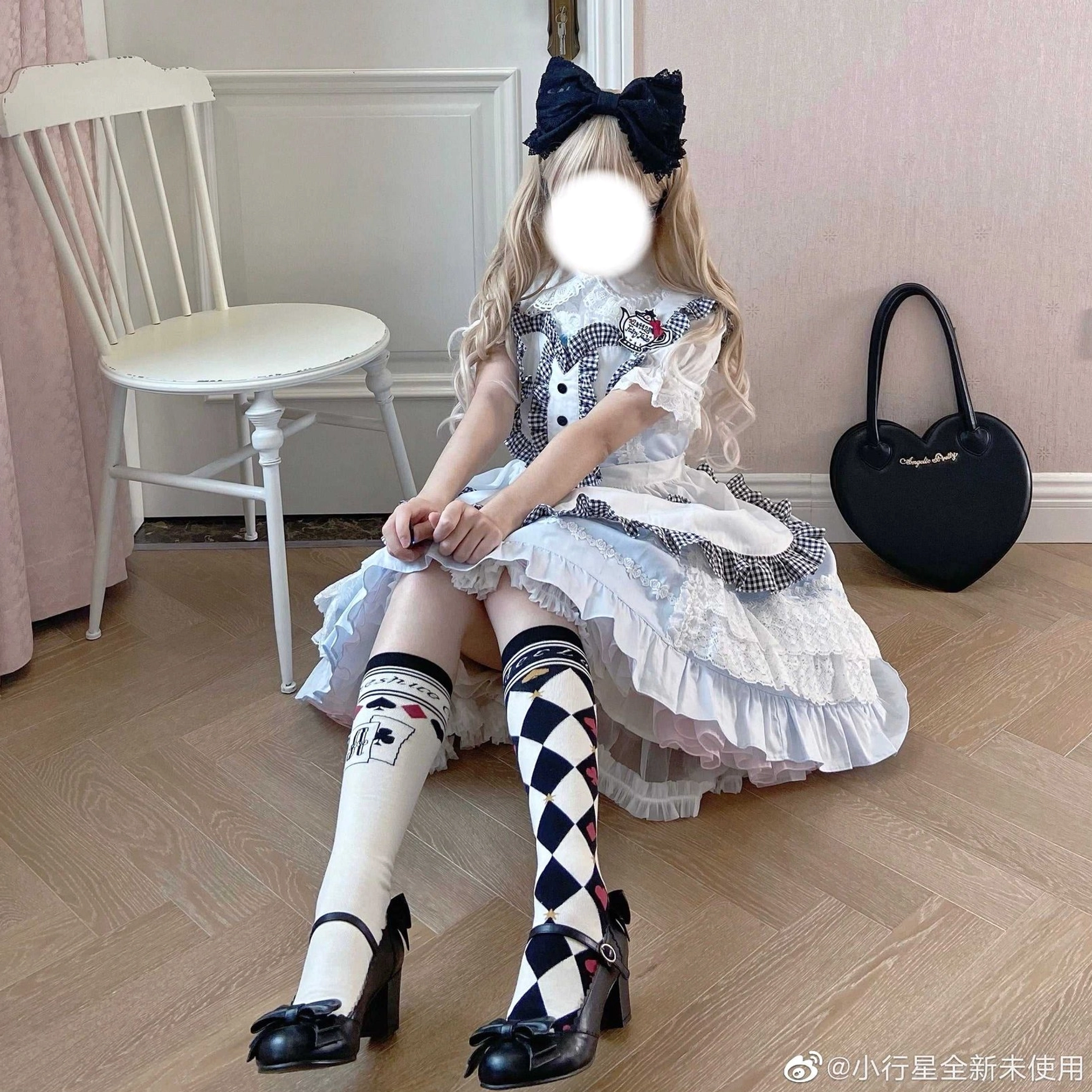 Asymmetrical print over-the-knee black and white checkerboard poker card lolita cotton socks worn with Alice maid dress and patent leather Mary Jane shoes sitting view