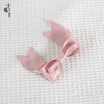 Baby pink satin bow hair clips pair matching bows split-tail design top-down flat lay view for romantic lolita aesthetic