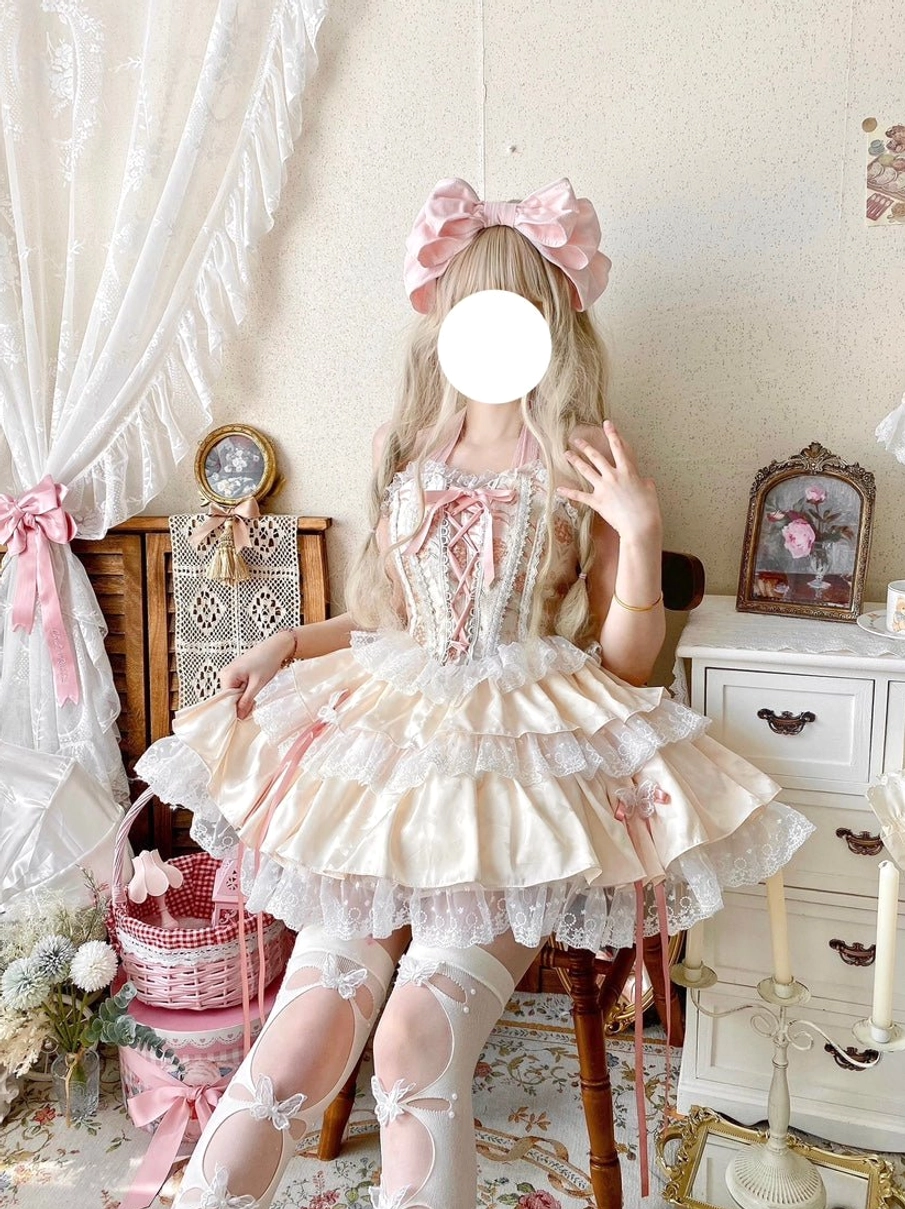 Ballet sweet lolita skirt set front three-quarter view featuring floral embroidery on bodice layered ruffled lace skirt matching pink hair bow accessory worn by blonde model in vintage bedroom setting