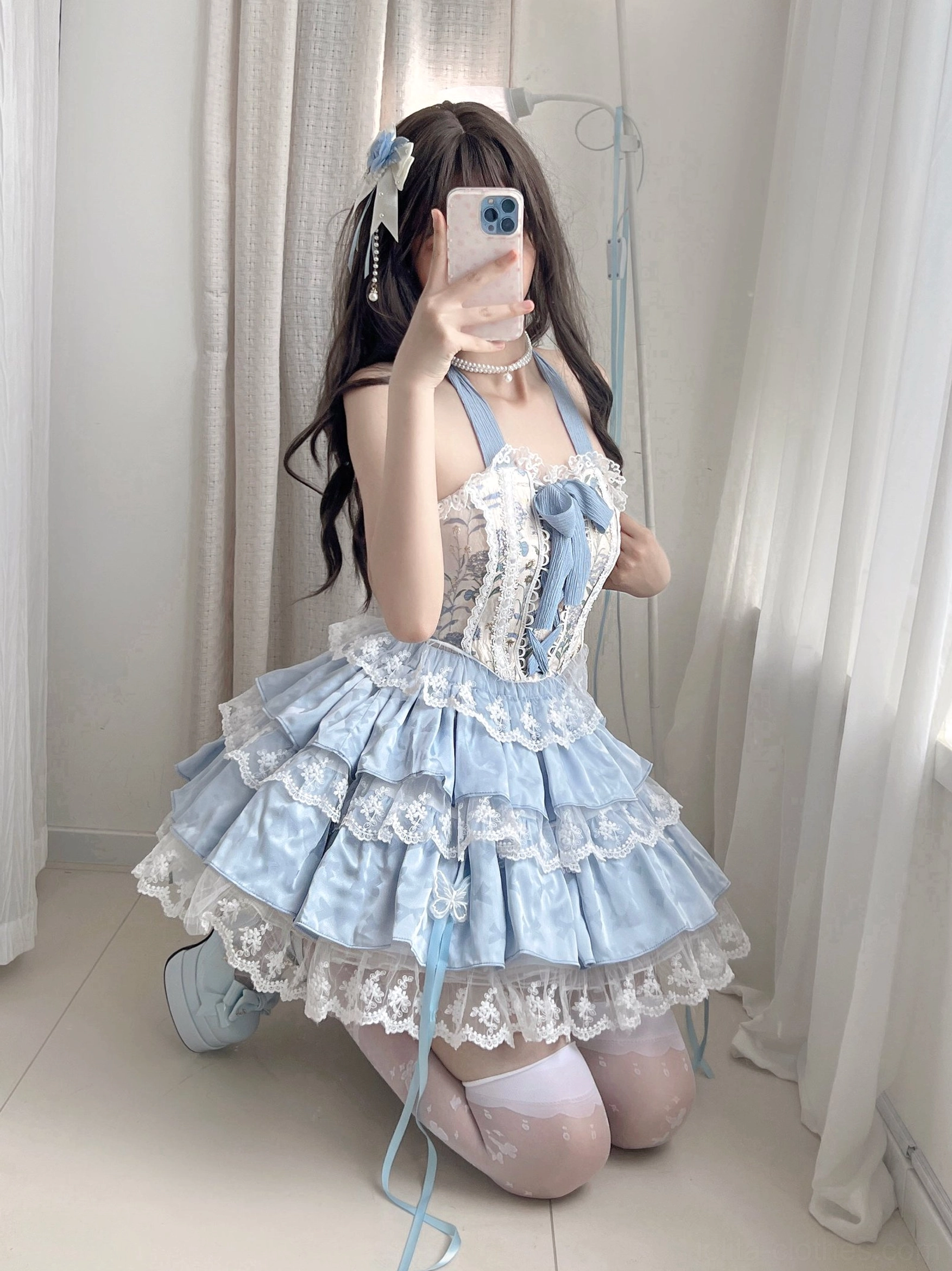 Ballet sweet lolita skirt set close-up detail showing floral brocade bodice multi-layer lace ruffled skirt with white thigh-high stockings sky blue low-angle kneeling pose indoor window scene