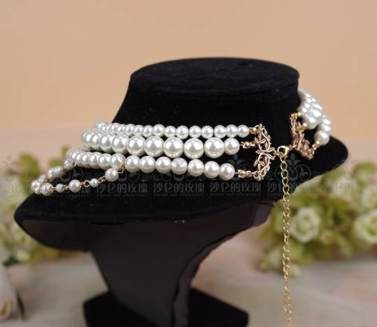 Back rear view of baroque pearl necklace showing closure hardware detachable extended chain and multi-row pearl band design