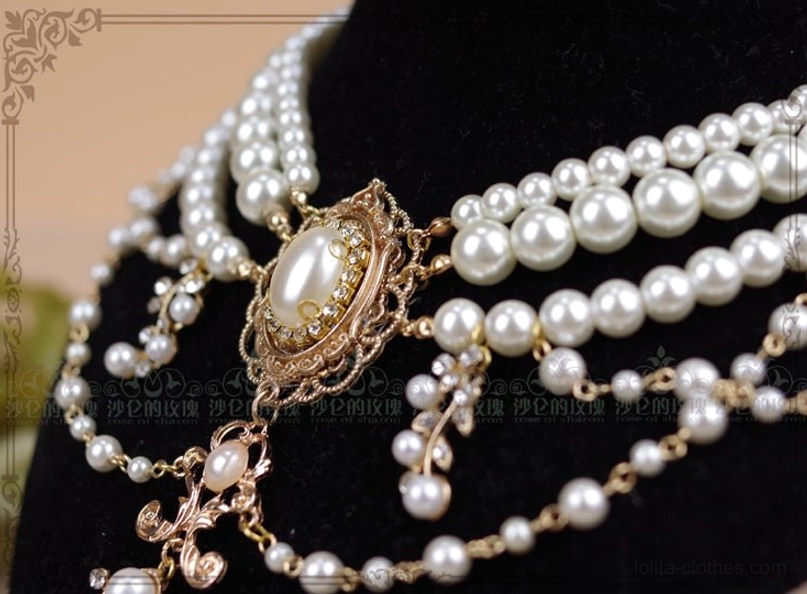 Side-front close-up detail shot of baroque pearl necklace showing left side filigree work and pearl strand layering with mannequin