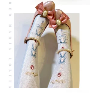Baroque pearl embroidered classic lolita tights worn with pink bow heels, close-up overhead shot showing intricate pearl ankle strap decoration and delicate lace embroidery on white-blue base