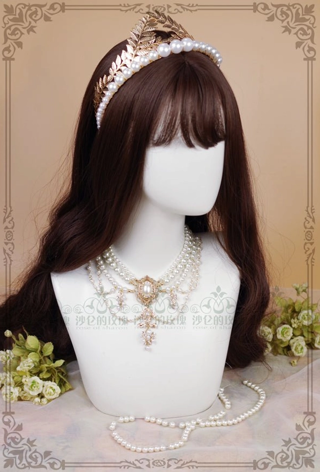 Styled overhead view of pearl necklace with matching tiara headpiece on mannequin with brown wig soft floral background wedding lolita set