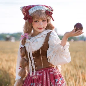 Bavarian folk lolita complete outfit worn outdoors in wheat field setting with cream embroidered blouse, brown corset vest, and red plaid skirt, model styled with red check headscarf and twin braids holding red apple