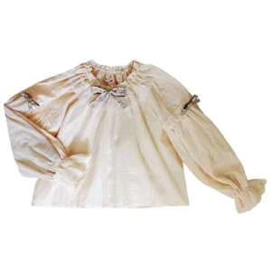 Bavarian folk lolita embroidered cotton blouse flat lay top view showing ruffled crew neck, chest bow embellishment, and lantern sleeves with buckle cuffs in cream color