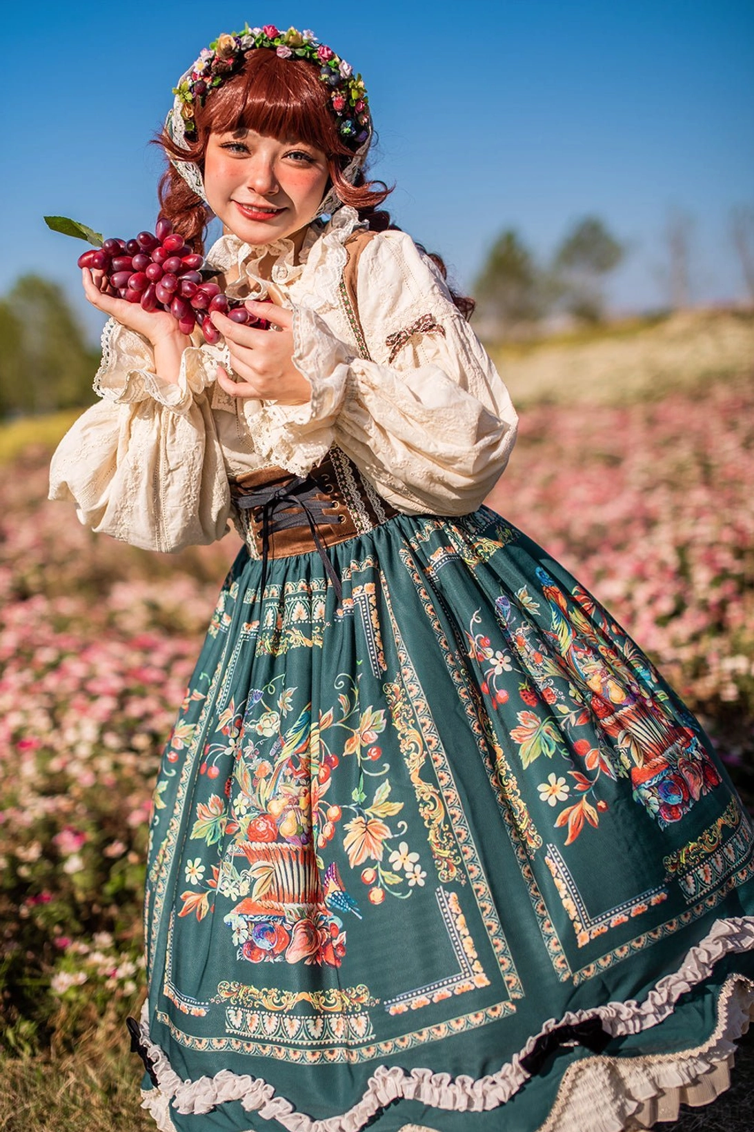 Bavarian Lolita JSK close-up showing ruffled skirt hem and detailed folk painting patterns with berry motifs