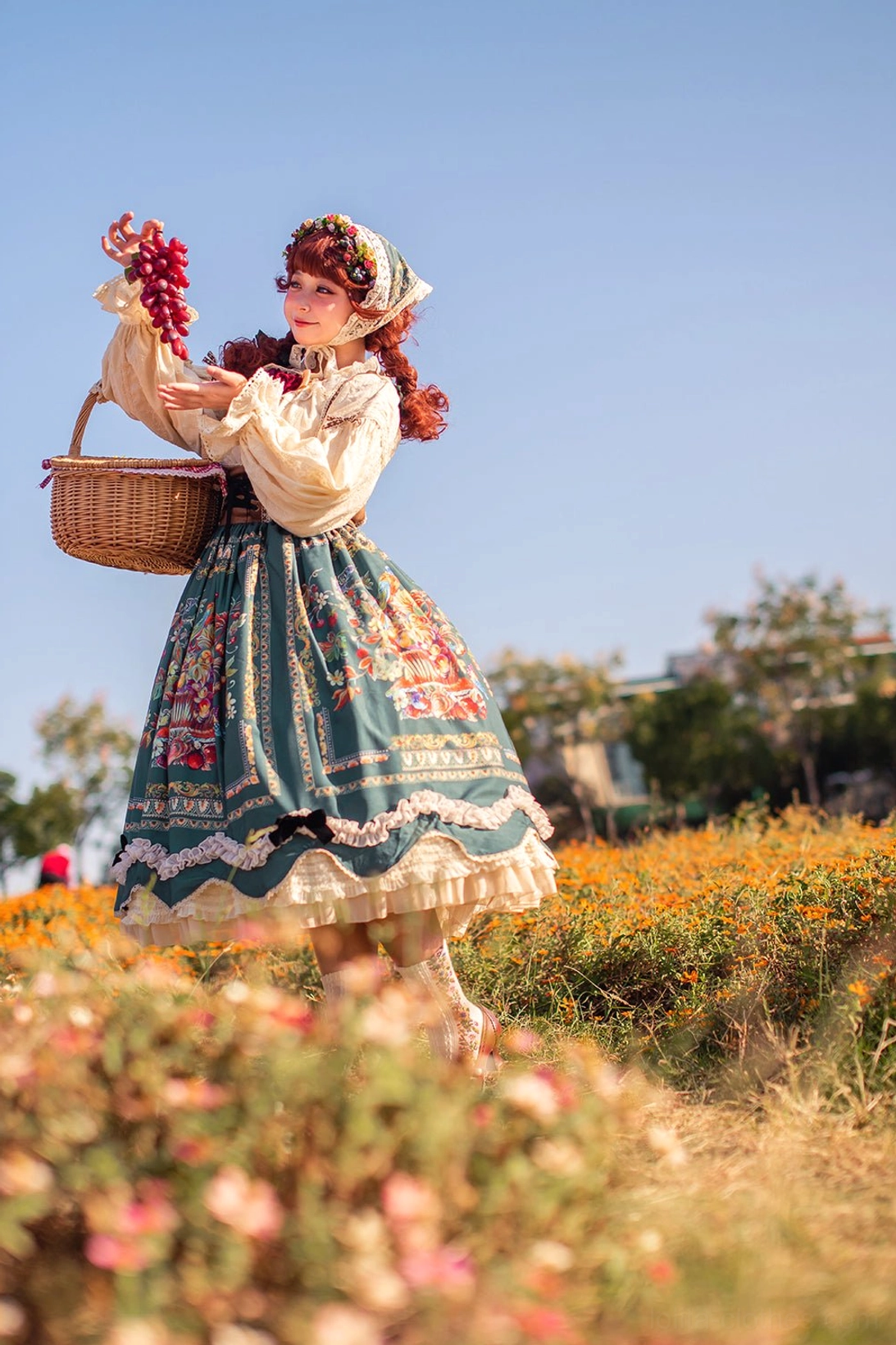Bavarian Lolita JSK low angle shot in yellow flower field wearing bonnet carrying basket
