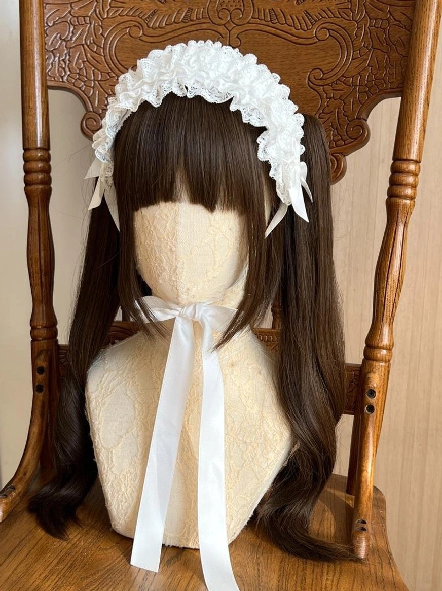 Elegant beige-colored lolita KC headdress on mannequin with brown twin ponytails, showing cream ruffled lace with satin bow and coordinating neck ribbon