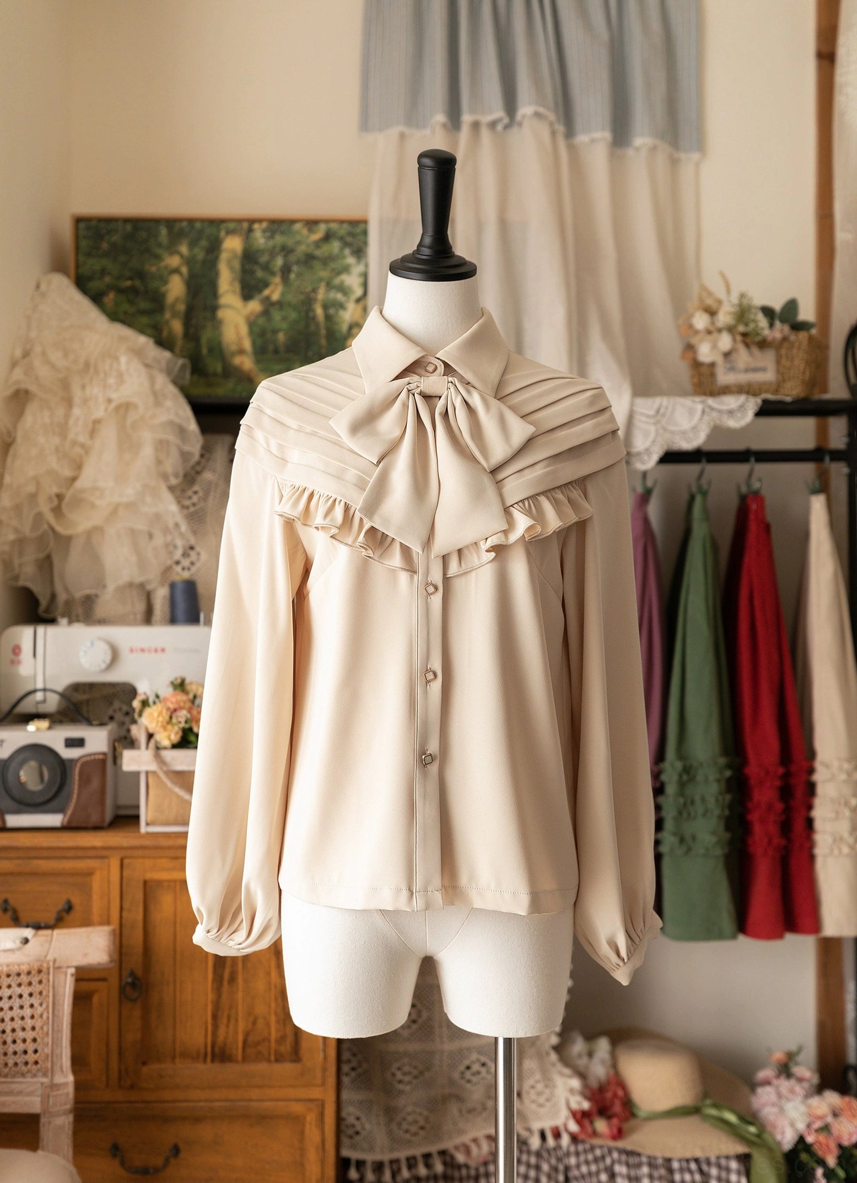 Beige ivory Lolita bow blouse with ruffled yoke and flowing bishop sleeves on dress form in retro boutique studio, front view showing button placket and romantic neutral fabric drape