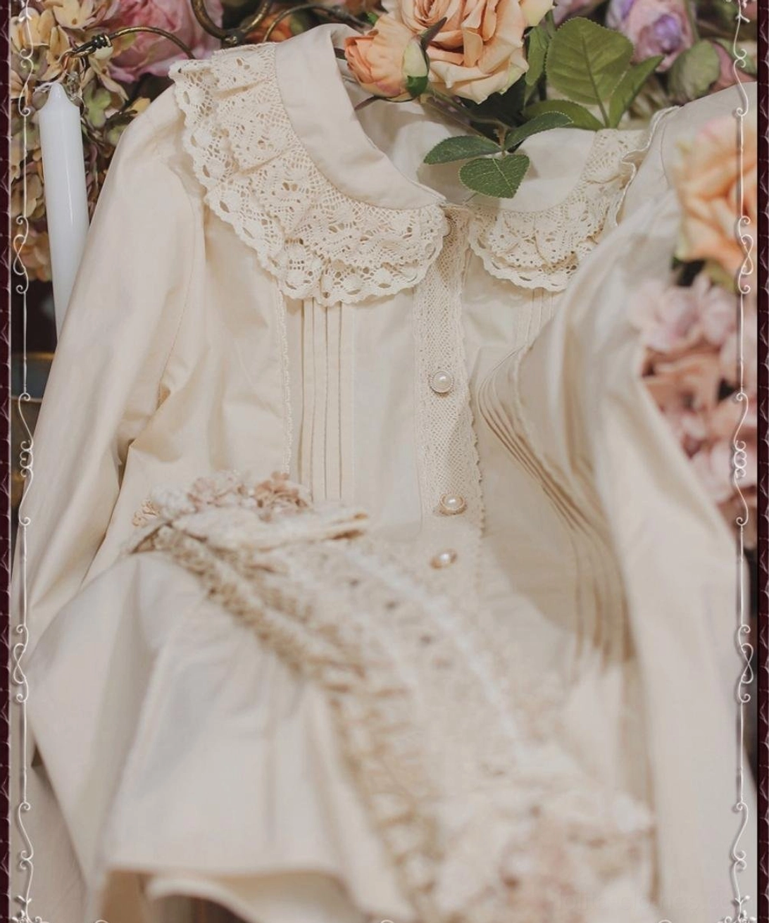 Beige vintage lace cotton Lolita blouse flat lay close-up top view showing delicate lace trim placket and smooth cotton fabric texture