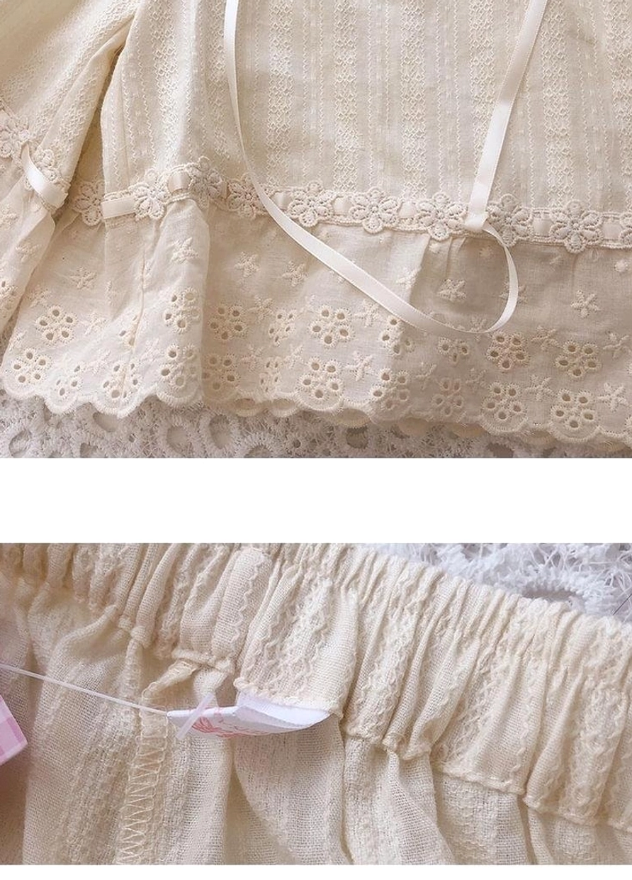 Close-up macro shot of beige premium lolita bloomers highlighting exquisite embroidered lace ruffled hem detail with scalloped edge, decorative side ribbon accent, elasticated waist craftsmanship, and soft premium cotton fabric texture on neutral background