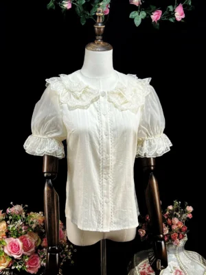 Beige sweet lolita doll collar blouse with lace trim double layer puff sleeves displayed on dress mannequin studio setting