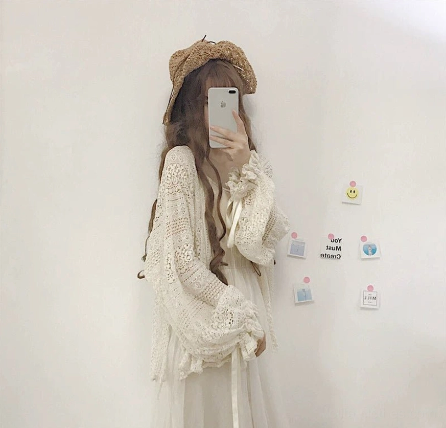 Beige oversized hollow crochet lolita cardigan product display showcasing entire garment with open front design and crocheted hollow knit construction