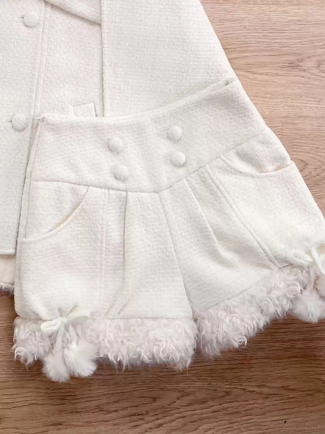 Beige rabbit pom-pom decorated lolita shorts isolated product photography showing structured puffed silhouette embellishment details and high-waisted construction