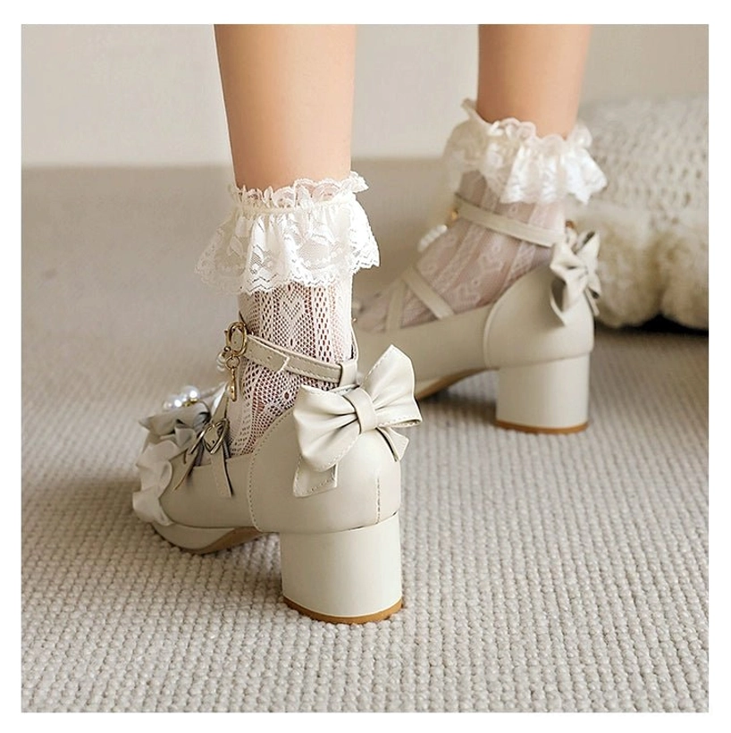 Beige round-toe sweet lolita heels back three-quarter view modeled with ruffled lace socks showing back bow decoration, cross straps with detachable pearl chain accessory, chunky block heel, and ruffle flower on toe cap