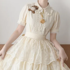 Beige vintage Lolita short-sleeve blouse with lace ruffled Peter Pan collar and puff sleeves worn with tiered ruffled lolita skirt front studio view