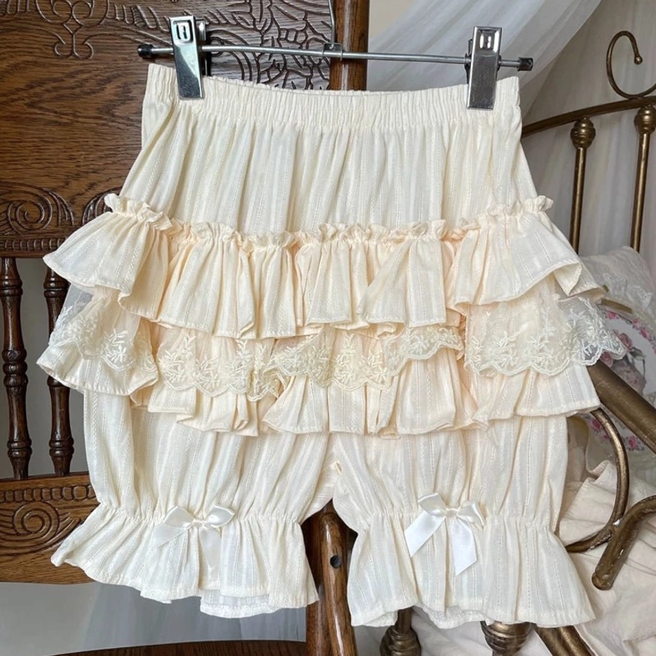 Cream beige sweet lolita cotton bloomers hanging display vintage wooden chair clothing hanger layered ruffles lace trim satin bows elastic waistband front view