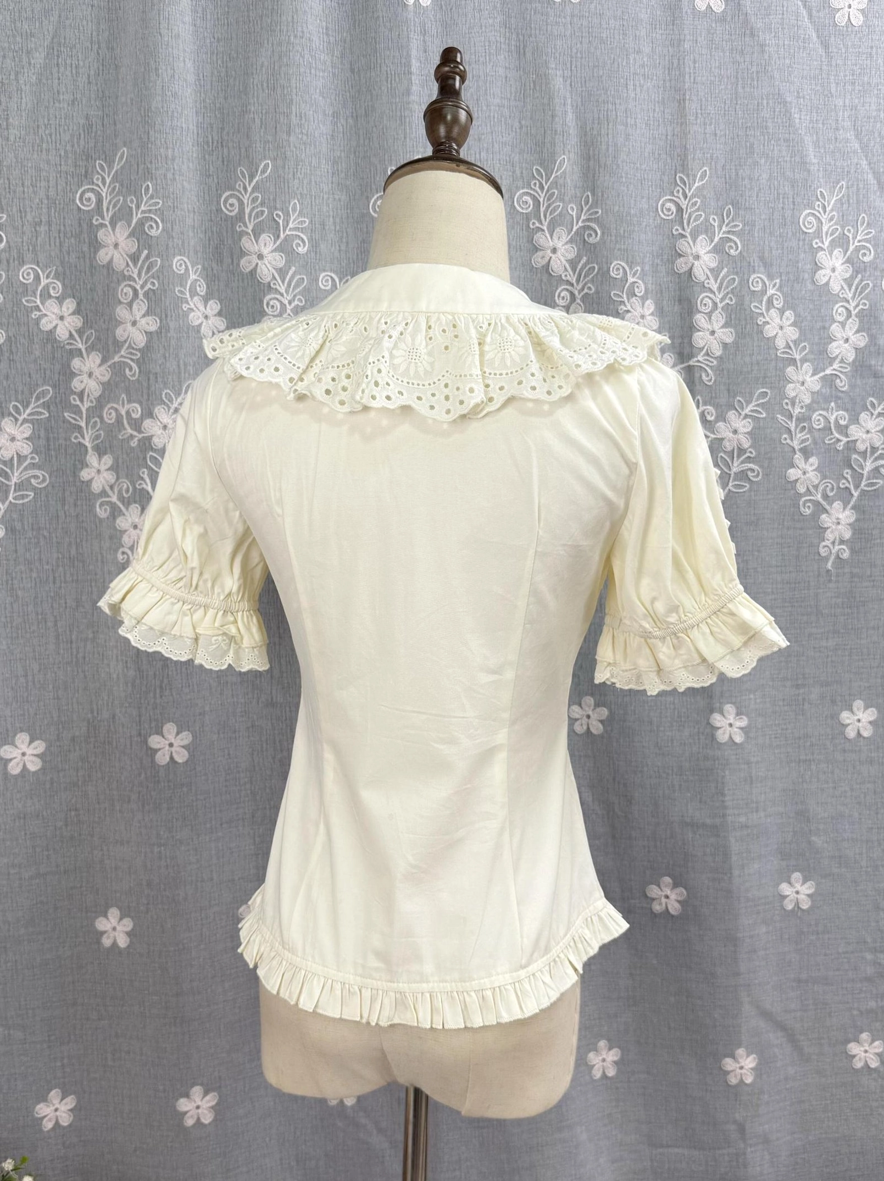 Light apricot beige Sweet Lolita Peter Pan collar blouse back flat view showing ruffled lace collar puff sleeves and hem
