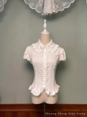 Bite The Cake white sweet lolita blouse front view featuring Peter Pan collar, vertical pinstripe fabric, cream-colored ruffles, and satin button closure on dress mannequin