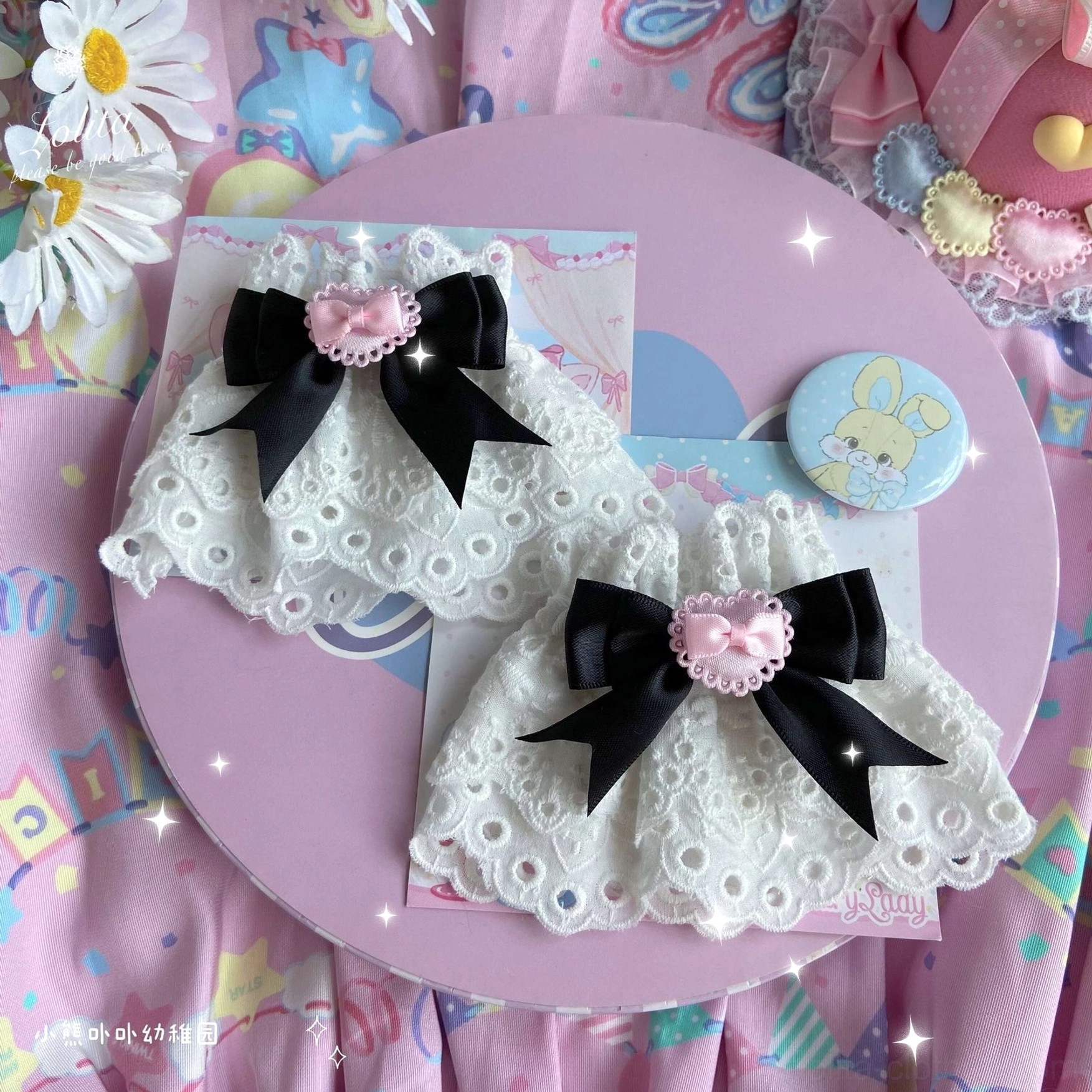 black bow lace wrist cuffs pair with pink heart accents white eyelet base sweet-gothic lolita style