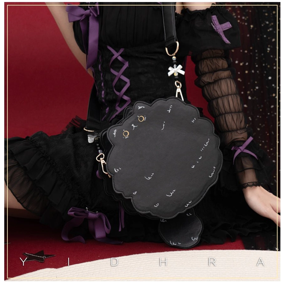 Black kawaii cat leather shoulder bag worn with gothic lolita black dress and red studio backdrop, showcasing side profile with scalloped silhouette and gold hardware details