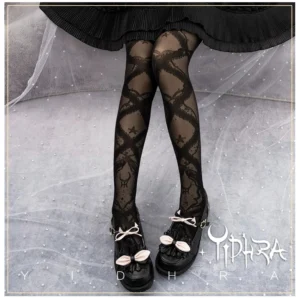 Black sheer lolita tights with celestial cross and deer head lace pattern worn with black lolita skirt and bow-decorated Mary Jane shoes - full leg front view