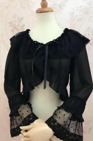Black sheer chiffon Lolita cropped blouse with embroidered doll collar and lace-trimmed ruffled cuffs, front view on dress form with vintage floral wallpaper background