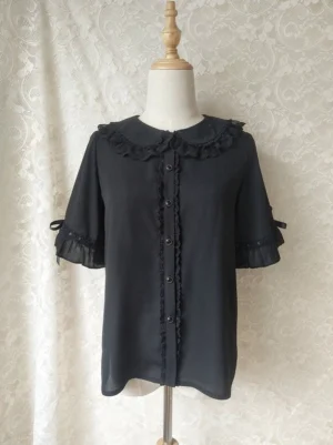 Black chiffon sweet lolita blouse displaying elegant lace-trimmed peter pan collar ruffled sleeves with black bow accents and lace front placket front flat lay dress form view