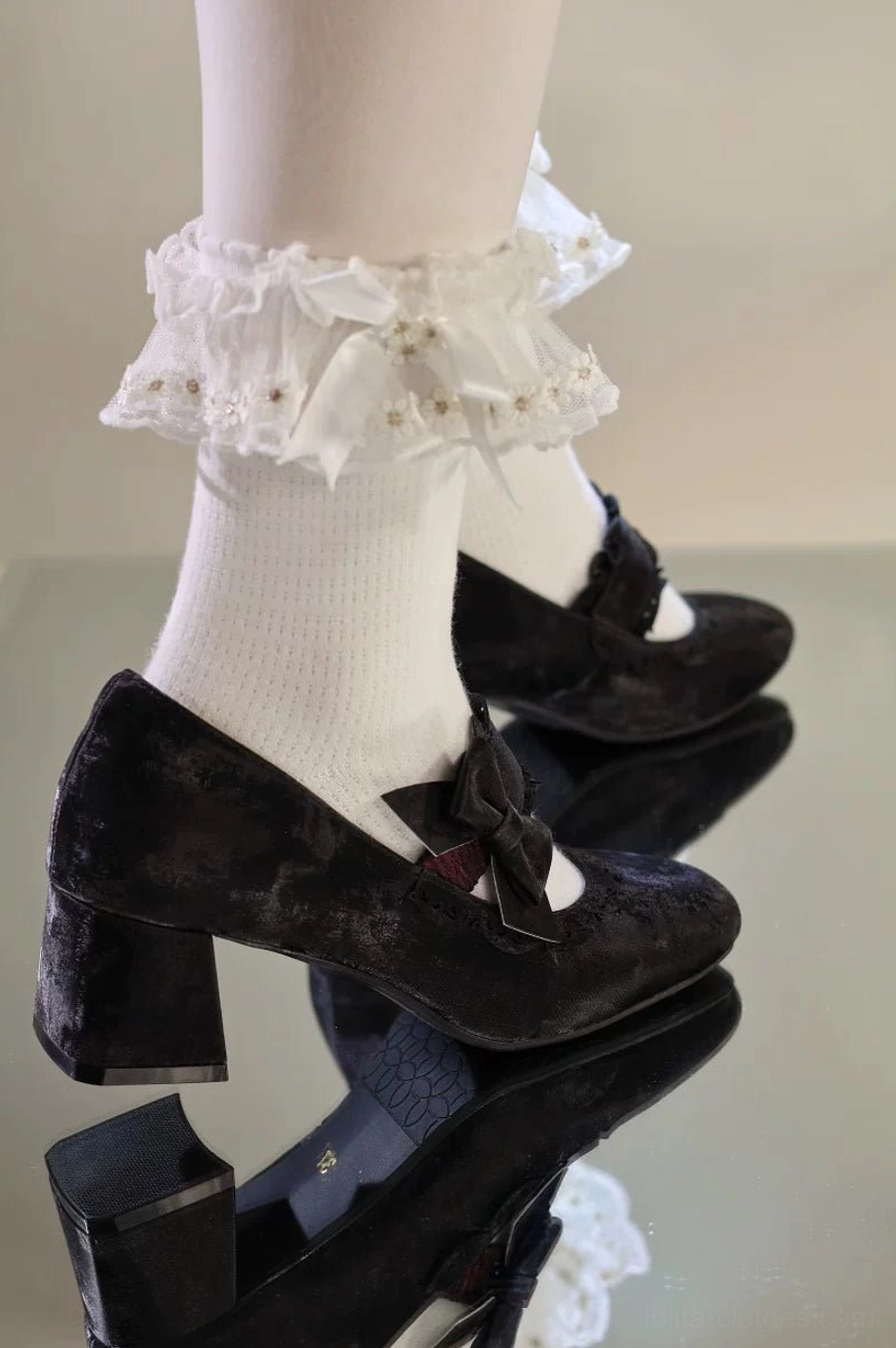 Black classic lolita chunky heel mary jane shoes with prominent decorative bow on ankle strap and cutout vamp trim, showcasing gothic lolita aesthetic and refined heel proportions