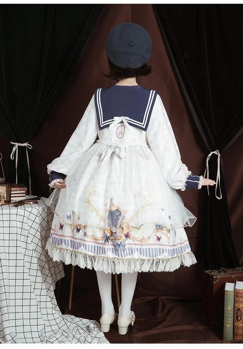 Black sailor collar classic lolita op dress back view on mannequin, black fabric, baroque floral print, black lace underskirt hem, long puff sleeves with lace cuffs